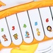 Đồ chơi đàn nhạc hình gà con CY.855-22A - mặt sau