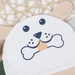 Mũ sơ sinh kẻ tăm KidsPlaza hình chó ND22T (Trắng be) - mặt trái